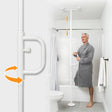 Man in a gray bathrobe using a white grab bar in a bathroom. - okotoks hc pharmacy