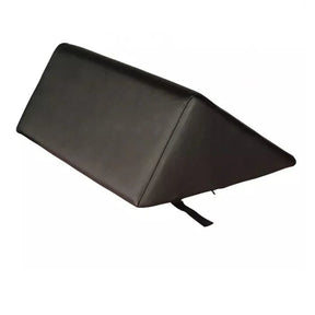 A black wedge-shaped support cushion or pillow with a small black strap hanging from the bottom corner, shown on a plain white background. - okotoks hc pharmacy