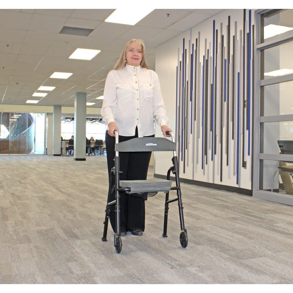 Person using a walker in an indoor setting with a modern design. - okotoks hc pharmacy