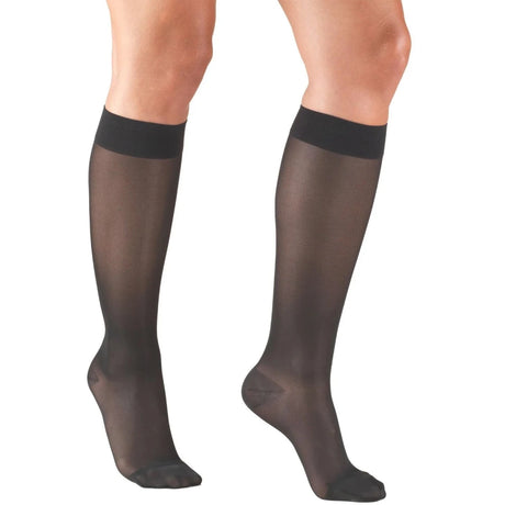 Black knee-high socks worn by a person on a white background - okotoks hc pharmacy