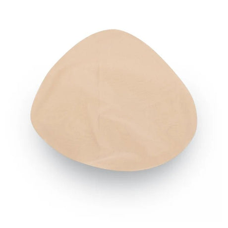 A single beige silicone or latex breast implant cup shown from a top-down view on a white background. - okotoks hc pharmacy