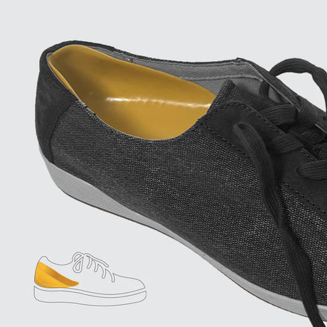 Black sneaker with yellow lining on a light gray background- okotoks hc pharmacy