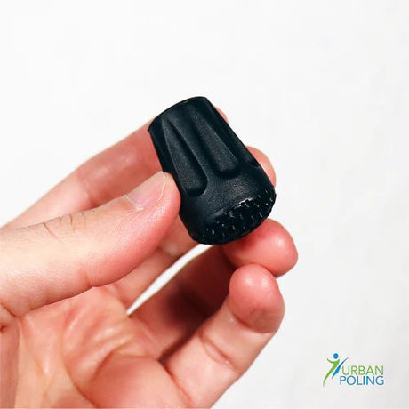 Black tip held in a hand with 'Urban Poling' logo in the corner. - okotoks hc pharmacy