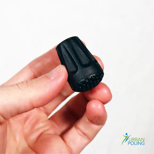 Black tip held in a hand with 'Urban Poling' logo in the corner. - okotoks hc pharmacy