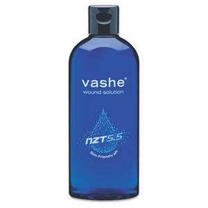 A blue plastic bottle of vashe wound solution with a dark gray cap, shown against a plain white background. - okotoks hc pharmacy