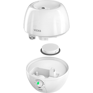 A white Vicks humidifier shown in an exploded view, with the top dome lid and bottom bowl base separated to display the internal components and control button. - okotoks hc pharmacy