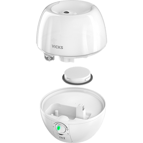 A white Vicks humidifier shown in an exploded view, with the top dome lid and bottom bowl base separated to display the internal components and control button. - okotoks hc pharmacy