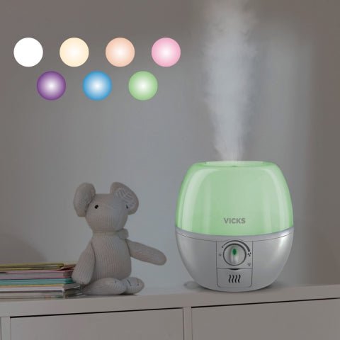 Vicks humidifier with colorful light bulbs on a shelf next to a stuffed animal - okotoks hc pharmacy
